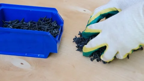 The builder puts the screws into the box. Stock Footage 156074912