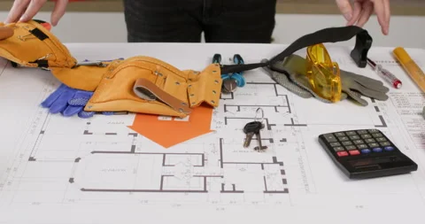 Builder puts tool belt on floor drawing with supplies Video stock 277442252