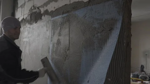 The builder puts on top of the mesh against the background of the second room Stock Footage 101663134