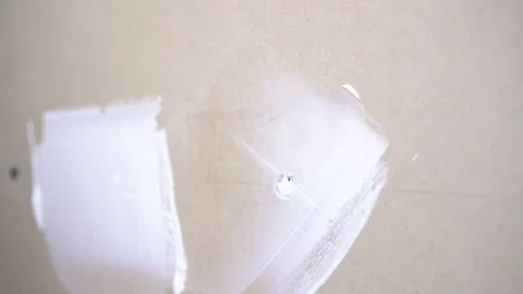 The builder putty the wall in the room close-up. The man makes repairs. Stock Footage 152036713