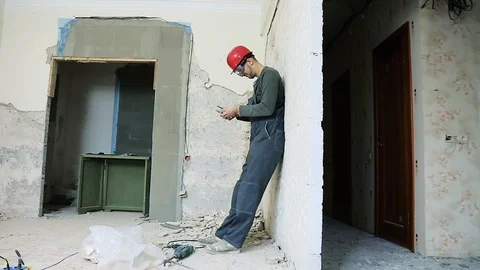 Builder in red helmet counts the money and is happy Stock Footage 112008307