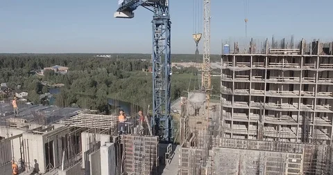 Builder removes the load from the tower crane during the construction building Stock Footage 105080281