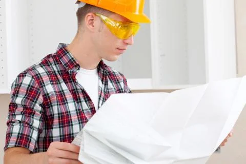 Builder with repair plan Stock Photos