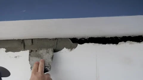 Builder Repairman Seals Up Crack In Wall With Spatula With Adhesive Solution Stock Footage 247495242