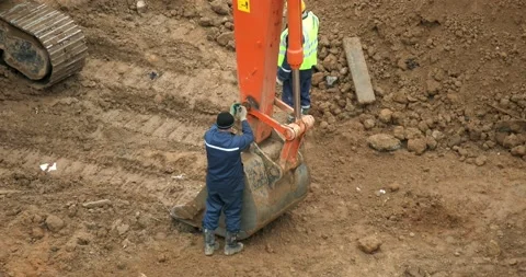 A builder repairs an excavator bucket. Stock Footage 166901888