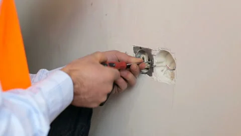 The builder repairs the outlet Stock Footage 104084496