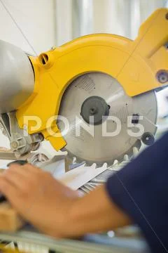 Builder sawing wood Stock Photos