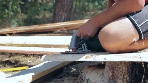 Builder sawing a wooden plank. Stock Footage