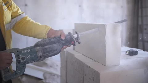 The builder saws bricks, saw Stock Footage 140592658