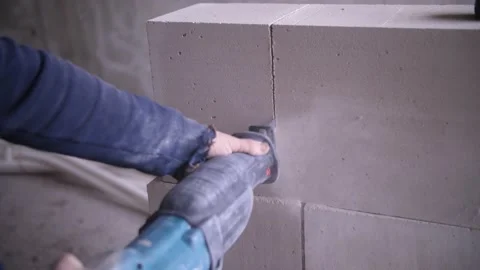 The builder saws bricks, saw Stock Footage 144145902