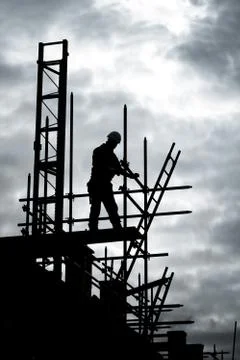 Builder on scaffold building site Stock Photos