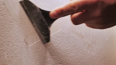 The builder scraped off the old paint. Spatula works on preparation of a surface Stock Footage 146341059