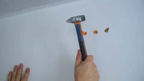 The Builder screws the screw into the wall Stock Footage 103949532