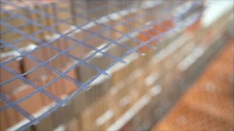The builder sets the grid during the construction of a house of brick. Buildi 스톡 사진
