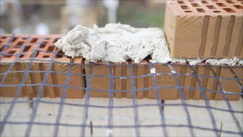 The builder sets the grid during the construction of a house of brick. Buildi Stock Photos