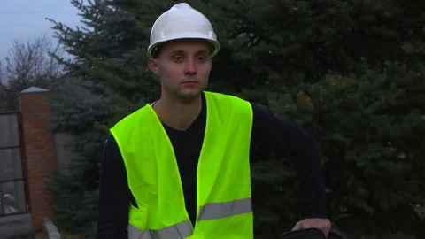 The builder sits with a chainsaw Stock Footage 75619430