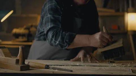 Builder, Small Business Owners Cleaning Workplace. Sweeps wood chips with a Video stock 242447928