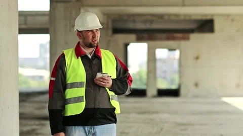 Builder with smartphone on construction site Stock Footage 86990669