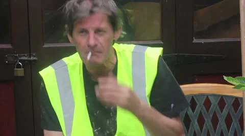 Builder  smokes and talks Stock Footage 25169698