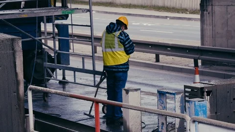 Builder is smoking on the street Stock Footage 85435141