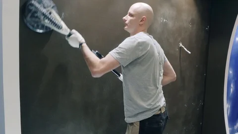 Builder smooths out black wall using grinding tool closeup Video stock 124607978