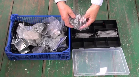 Builder sorting out nails Stock Footage 68724246