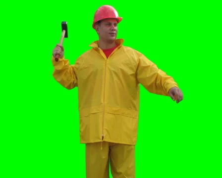 Builder spins with hammer on the Green Screen LOOP PAL Stock Footage 1059425
