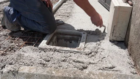 Builder spreading and levelling fresh cement solution with industrial metal Video stock 228939406