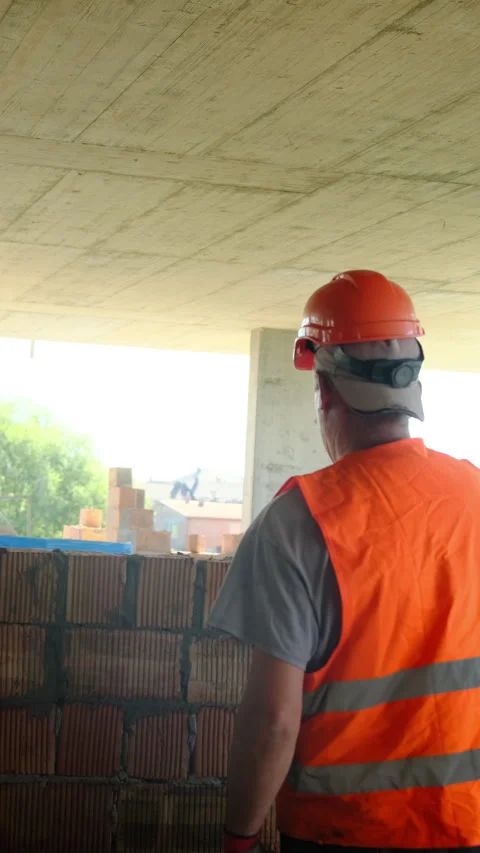 Builder spreads mortar on surface of bricks creating wall Stock Footage 317621160