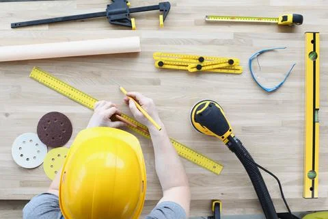 Builder spreads tools on table for repairs Stock Photos
