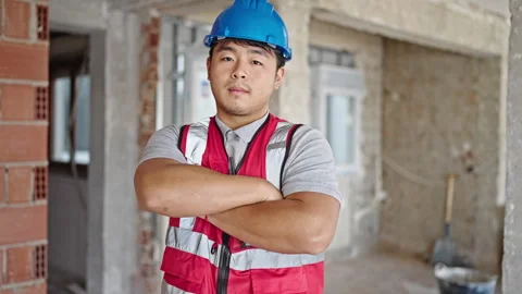 Builder standing with arms crossed gesture and serious expression at constr.. Stock Footage 247386793