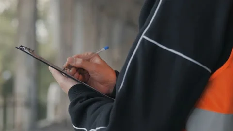 A Builder standing in a building under construction makes notes on a tablet. Stock Footage 132492076