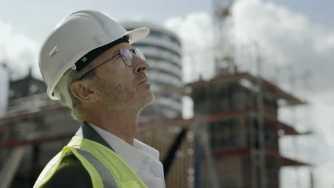 Builder standing on construction site and looking around Video stock 167024744