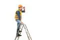 The builder standing on the ladder on the white background Photo