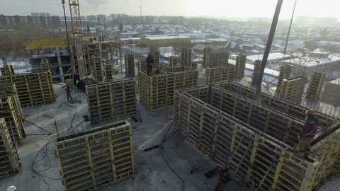 Builder stands on the wall and the building hose with cement moves closer to him Stock Footage 82017857
