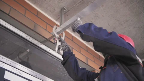 The builder takes measurements, worker in uniform. Stock Footage 238693396