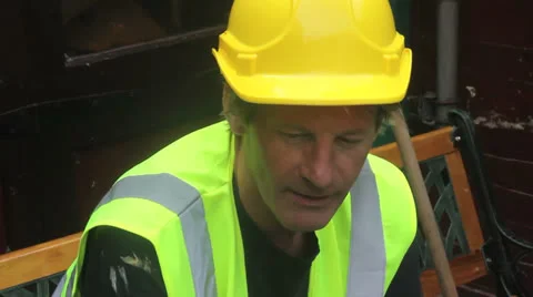 Builder talks and relexs Stock Footage 25169683