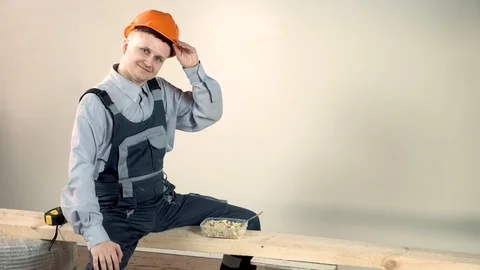 The builder is tired and ready to taste the delicious lunch. Building snack Stock Footage 102776972