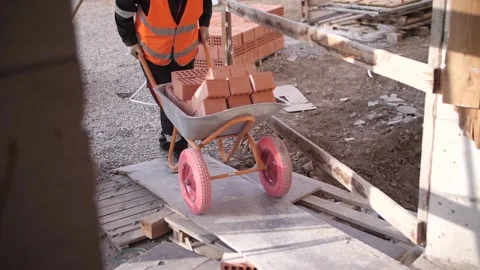 The builder is transporting bricks Stock Footage 140591888