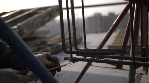 The builder twists the metal frame Stock Footage 142285779