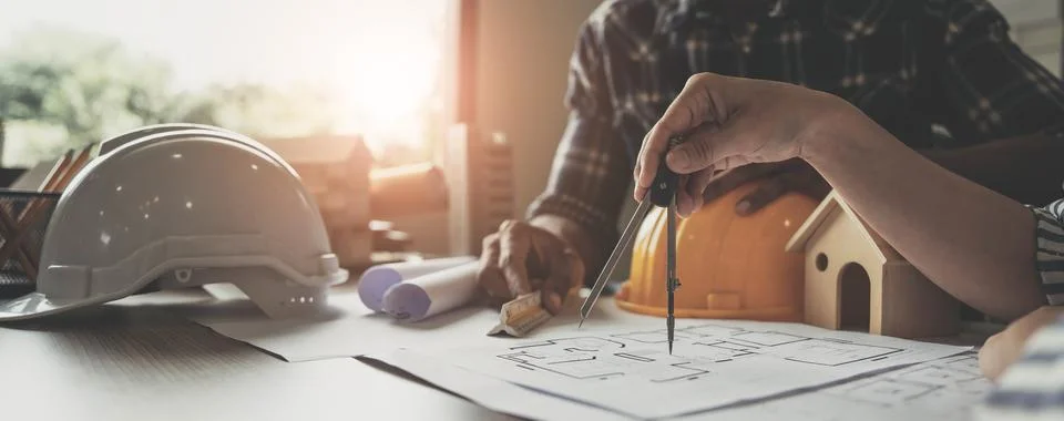 Builder two asian young engineer man and architect woman are discussing Stock Photos