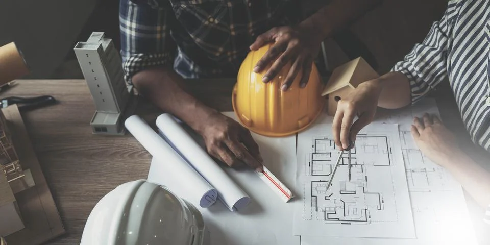 Builder two asian young engineer man and architect woman are discussing Stock Photos