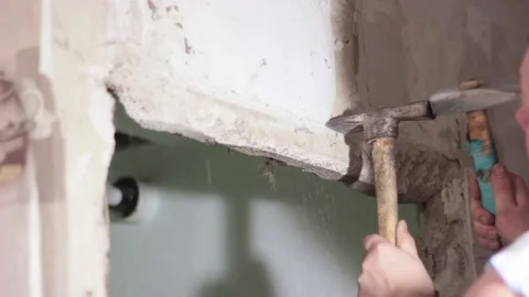 Builder two hammers break the concrete wall Stock Footage 74794494