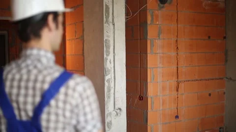 Builder in unfinished room Video stock 61729327