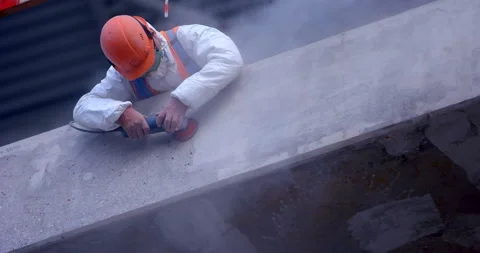 A builder in uniform is working on scaffolding on rough grinding the wall  Stock Footage 119624966