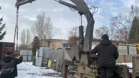 A builder unloads wooden blocks while operating a crane. Stock Footage 301503340