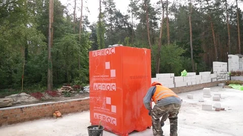 A builder unpacks a package of blocks for building walls6 Stock Footage 325519045
