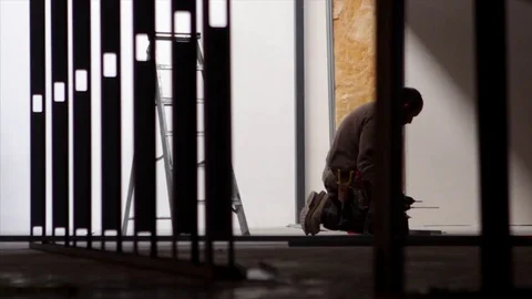 Builder uses a drill on a construction site 스톡 동영상 78770810