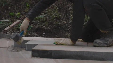 The builder uses a special mallet hammer to adjust the correct location of the Stock Footage 291199509