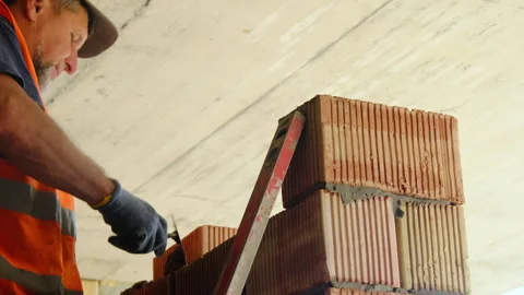 Builder uses trowel to cover brick with special substance Video stock 317606032